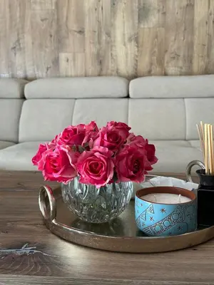 a vase filled with pink roses on a coffee table at CityLink-3Bedrooms Appartment CityCenter in Limassol