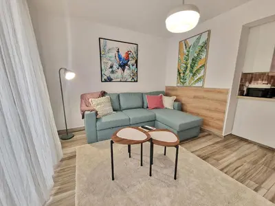 a living room with a blue couch and two tables at 1, bed Kapparis, Triumph 1 - A in Paralimni