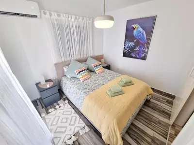 a bedroom with a bed and a painting on the wall at 1, bed Kapparis, Triumph 1 - A in Paralimni