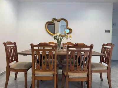 a dining room table with chairs and a mirror at Bella's Place - Stylish 2BD With large Veranda in Larnaka