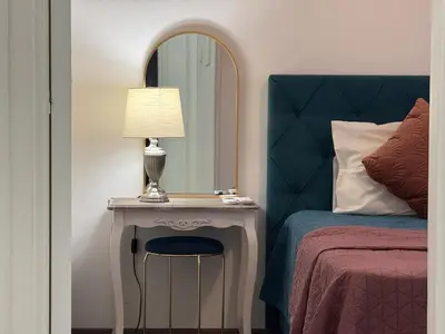 a bedroom with a bed and a table with a lamp at Bella's Place - Stylish 2BD With large Veranda in Larnaka