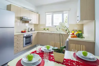 a kitchen with a table with two plates of food on it at Omerou Apartment in Nicosia