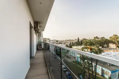 a balcony with a view of a city at Fam Glam Comfort Apartment in Larnaka