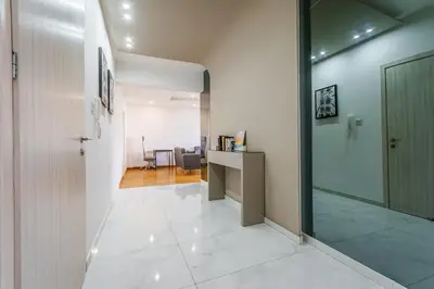 an office corridor with a glass door and a desk at Fam Glam Comfort Apartment in Larnaka