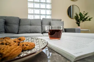 a plate of cookies and a glass of tea on a table at 1 bedroom flat near center in Nicosia