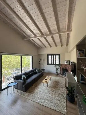 a living room with a couch and a table at Loft 17 - fully renovated loft in centre in Limassol