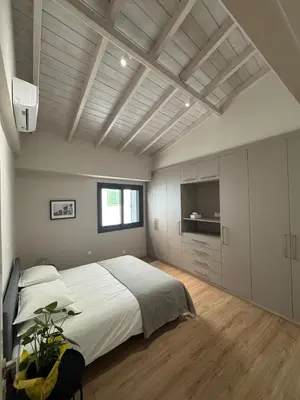 a bedroom with a large bed and a television at Loft 17 - fully renovated loft in centre in Limassol