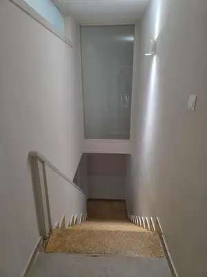 a hallway with a staircase with a large window at Loft 17 - fully renovated loft in centre in Limassol