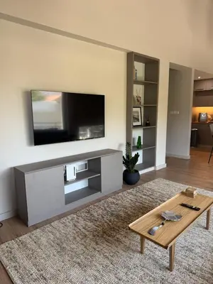 a living room with a flat screen tv on a wall at Loft 17 - fully renovated loft in centre in Limassol