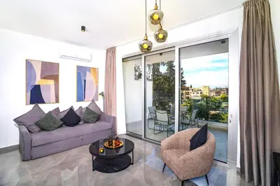 a living room with a purple couch and a table at Celeste Suites in Limassol