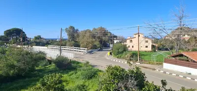an empty road in a small town with a building at The river house in Kato Pyrgos