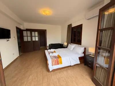 a bedroom with a large bed and a television at Villa Encanto - Private Heated Swimming Pool for winter months 5Bedroom in Voroklini
