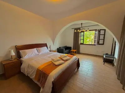 a bedroom with a bed and an arched window at Villa Encanto - Private Heated Swimming Pool for winter months 5Bedroom in Voroklini
