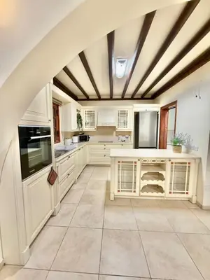a kitchen with white cabinets and a coffered ceiling at Villa Encanto - Private Heated Swimming Pool for winter months 5Bedroom in Voroklini