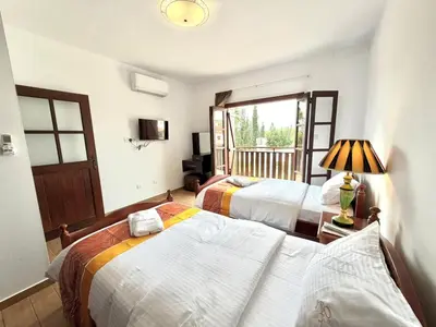 a bedroom with two beds and a balcony at Villa Encanto - Private Heated Swimming Pool for winter months 5Bedroom in Voroklini