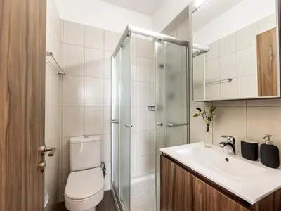 a bathroom with a shower and a toilet and a sink at Mythical Sands AL14 in Paralimni