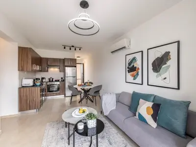 a living room with a couch and a table at Mythical Sands AL14 in Paralimni