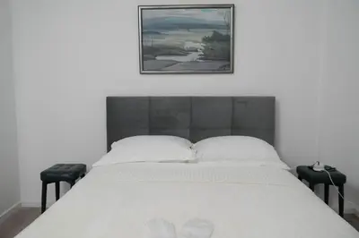 a bedroom with a bed with a picture on the wall at Athalassas corner in Strovolos