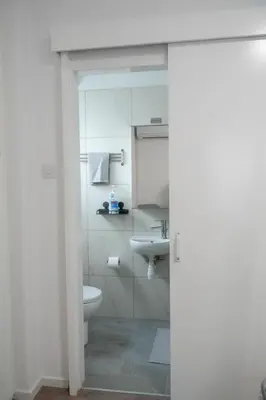a bathroom with a toilet and a sink at Athalassas corner in Strovolos