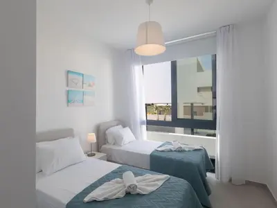 a bedroom with two beds and a window at Holiday Home Protaras Aqua Pearl Villa AQ16 by Interhome in Protaras