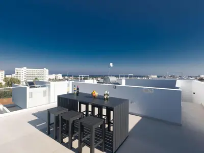 a balcony with a black table and chairs on a roof at Holiday Home Protaras Aqua Pearl Villa AQ16 by Interhome in Protaras