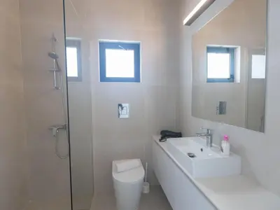 a bathroom with a toilet and a sink and a shower at Holiday Home Protaras Aqua Pearl Villa AQ16 by Interhome in Protaras