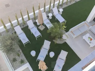 an overhead view of a lawn with chairs and umbrellas at Holiday Home Protaras Aqua Pearl Villa AQ16 by Interhome in Protaras