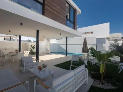 a patio with white furniture and a swimming pool at Holiday Home Protaras Aqua Pearl Villa AQ16 by Interhome in Protaras