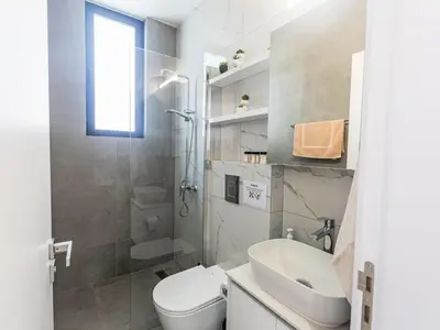a white bathroom with a toilet and a sink at Holiday Home Protaras Aqua Pearl Villa AQ18 mit Poolheizung by Interhome in Protaras