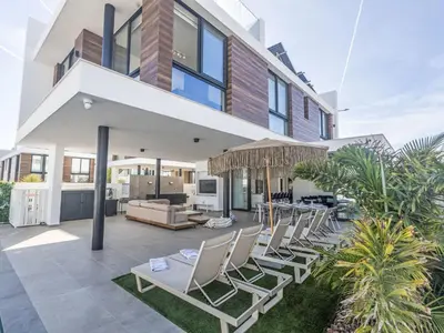 a house with a patio with chairs and a table at Holiday Home Protaras Aqua Pearl Villa AQ18 mit Poolheizung by Interhome in Protaras