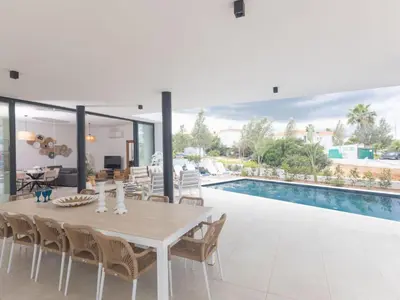 a dining room with a table and a swimming pool at Holiday Home Protaras Aqua Pearl Villa AQ01 by Interhome in Protaras