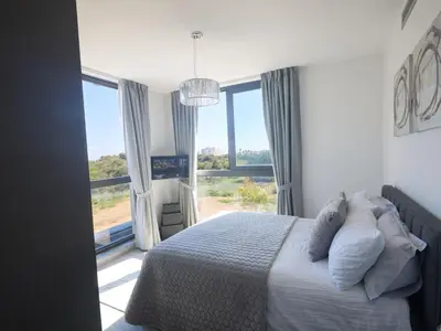 a bedroom with a bed and a large window at Holiday Home Protaras Almaria Villa ALM08 by Interhome in Protaras
