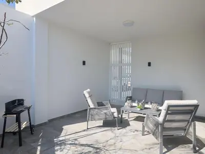 a living room with two chairs and a table at Holiday Home Protaras Almaria Villa ALM08 by Interhome in Protaras
