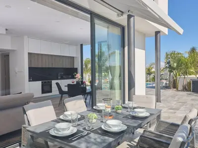 a dining table and chairs in a house at Holiday Home Protaras Almaria Villa ALM08 by Interhome in Protaras