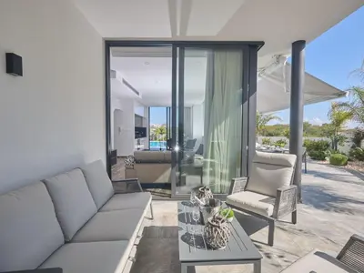 a living room with a couch and a table at Holiday Home Protaras Almaria Villa ALM08 by Interhome in Protaras