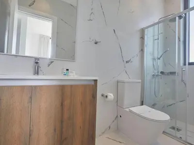 a bathroom with a toilet and a shower and a mirror at Holiday Home Protaras Almaria Villa ALM08 by Interhome in Protaras