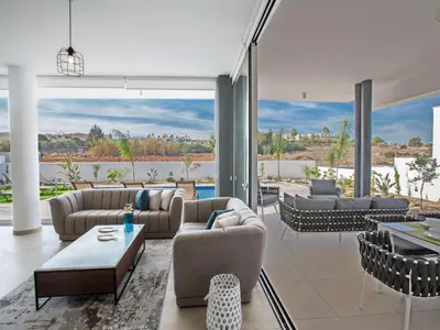 a living room with couches and tables and windows at Holiday Home 3-Schlafzimmer-Villa mit privatem Pool im Zentrum by Interhome in Protaras
