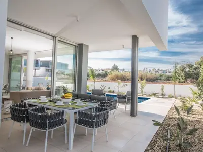 a dining room with a table and chairs at Holiday Home 3-Schlafzimmer-Villa mit privatem Pool im Zentrum by Interhome in Protaras