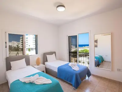 a bedroom with two beds and a balcony at Holiday Home in Protaras mit privatem Parkplatz by Interhome in Protaras