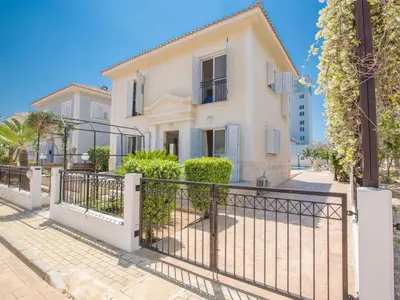 a white house with a fence and bushes at Holiday Home in Protaras mit privatem Parkplatz by Interhome in Protaras