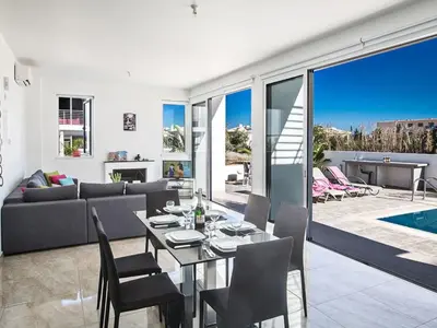 a living room with a table and chairs and a couch at Holiday Home Protaras Perle Villa PE15 by Interhome in Protaras