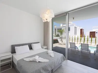 a bedroom with a bed with white towels on it at Holiday Home Protaras Olivine Villa OL9 by Interhome in Protaras