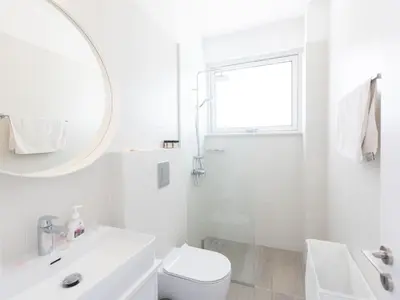 a white bathroom with a sink toilet and a mirror at Holiday Home Protaras Olivine Villa OL9 by Interhome in Protaras