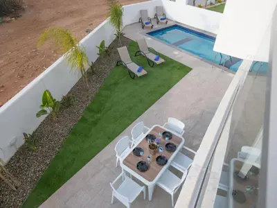 an overhead view of a patio with a table and chairs and a pool at Holiday Home 2-Schlafzimmer-Villa mit Pool- Dachgarten- Meerblick by Interhome in Protaras
