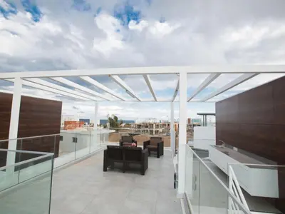 a balcony with a view of a building at Holiday Home 2-Schlafzimmer-Villa mit Pool- Dachgarten- Meerblick by Interhome in Protaras