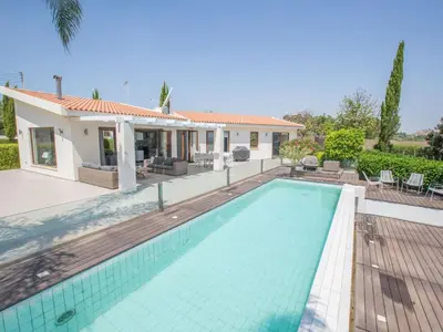 a swimming pool in front of a house at Holiday Home 4-Schlafzimmer-Villa mit Pool im Zentrum von Protaras by Interhome in Protaras