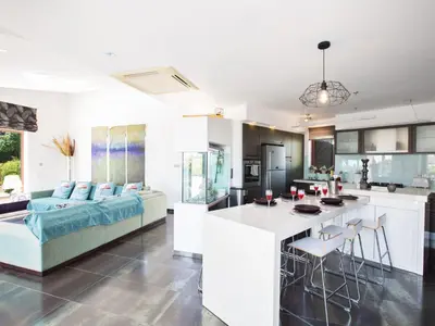 a kitchen and living room with a couch and a table at Holiday Home 4-Schlafzimmer-Villa mit Pool im Zentrum von Protaras by Interhome in Protaras