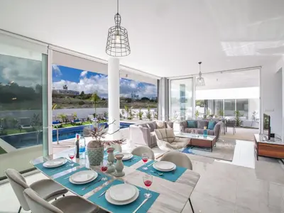 a living room with a table and chairs at Holiday Home 3-Schlafzimmer-Villa mit privatem Pool im Zentrum by Interhome in Protaras