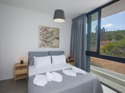 a bedroom with a bed and a large window at Holiday Home Protaras Elite Perle Villa EP3C by Interhome in Protaras