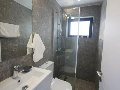 a bathroom with a shower and a toilet and a sink at Holiday Home Protaras Elite Perle Villa EP3C by Interhome in Protaras